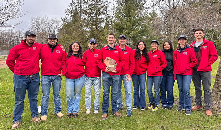 Plant Science club competitors stand with award.